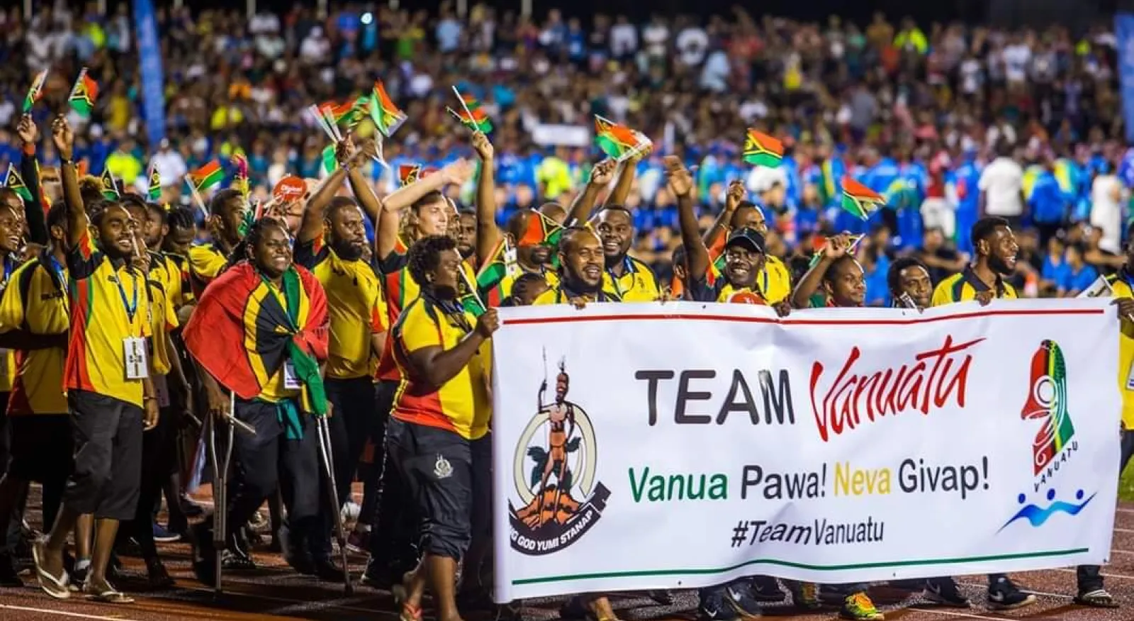 A team of athletes from Vanuatu holding up little flags of Vanuatu.