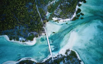 Aerial view of a bridge spanning the ocean in Kiribati, showcasing the stunning beauty of the country.