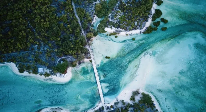 Aerial view of a bridge spanning the ocean in Kiribati, showcasing the stunning beauty of the country.