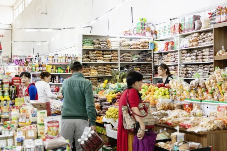 A busy market with lots of produce on display