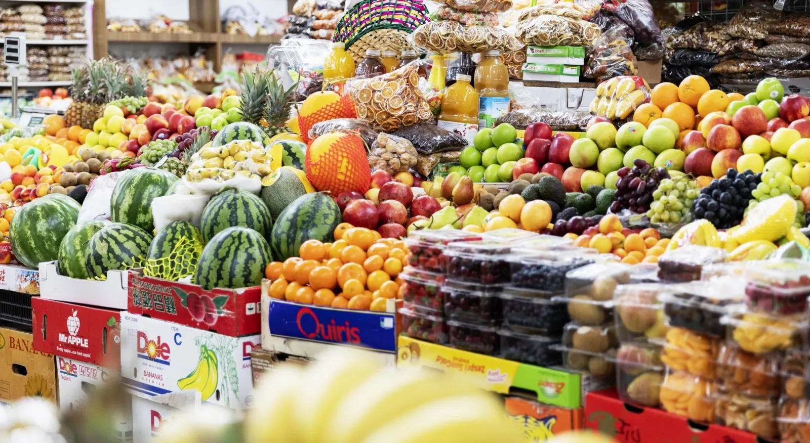 A local Market featuring fruit, vegetables, meat and dairy products from the city of Ulaanbaatar, Mongolia. The boxes are full of colorful fruit and vegetables.