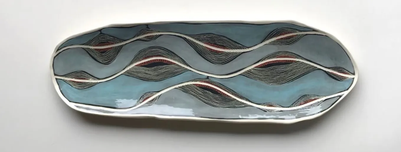 The background is light blue, with maroon and white lines symbolising a river.