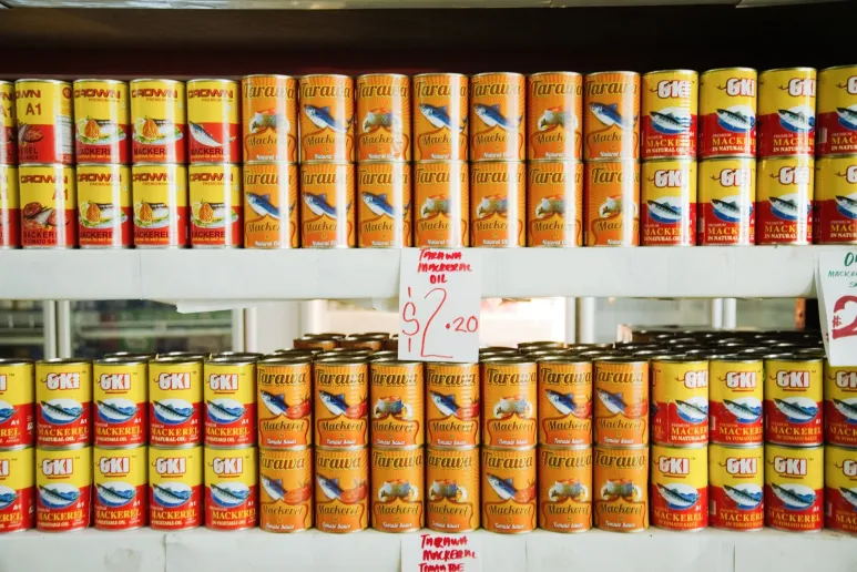 Stacks of tinned fish in a supermarket.