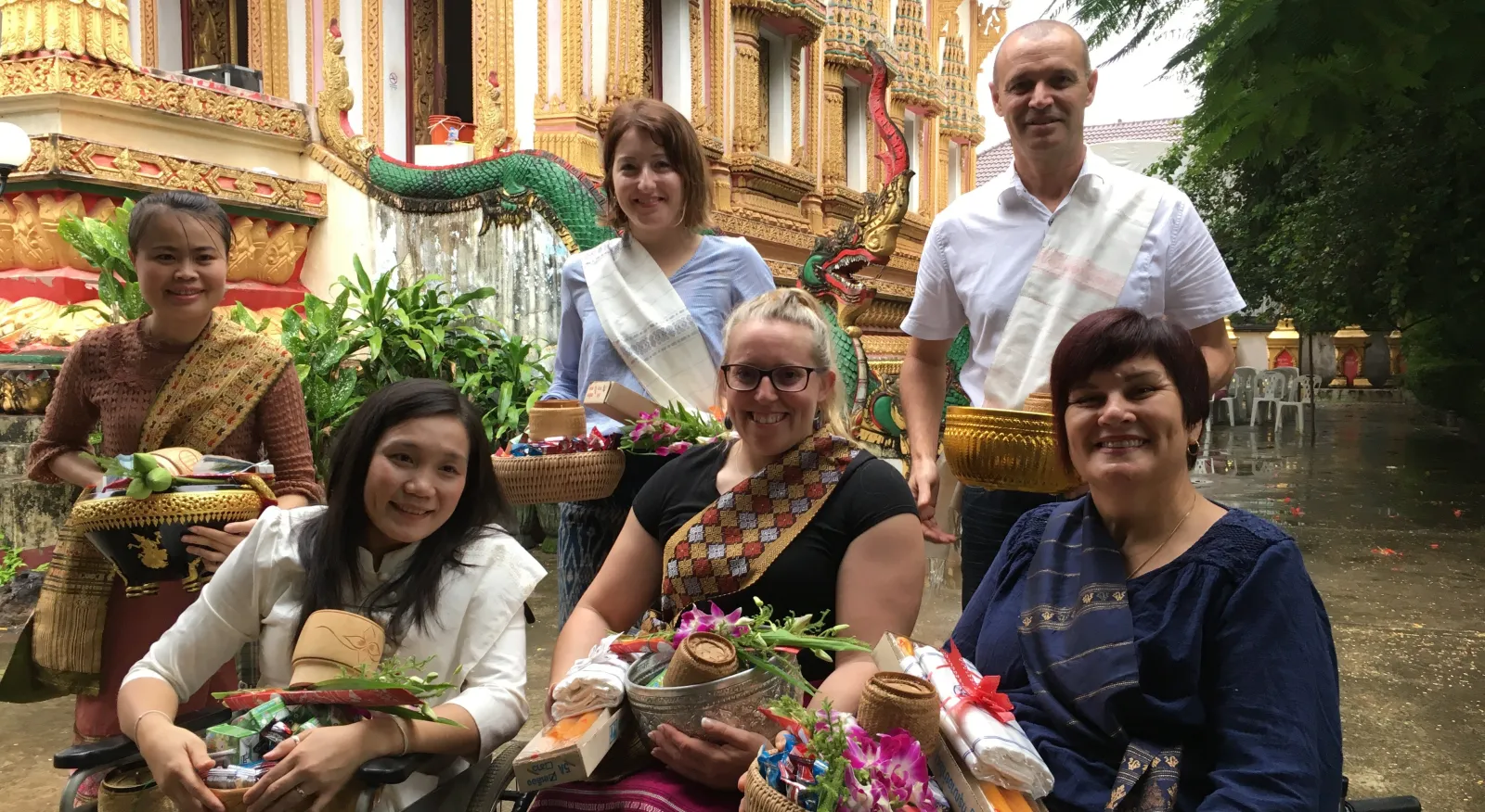 A group of people in wheelchairs with baskets of flowers