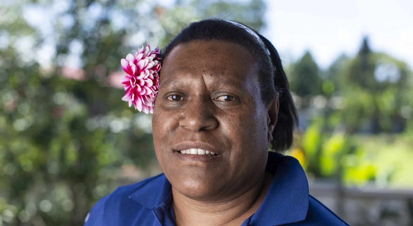 A woman with a flower in her hair.