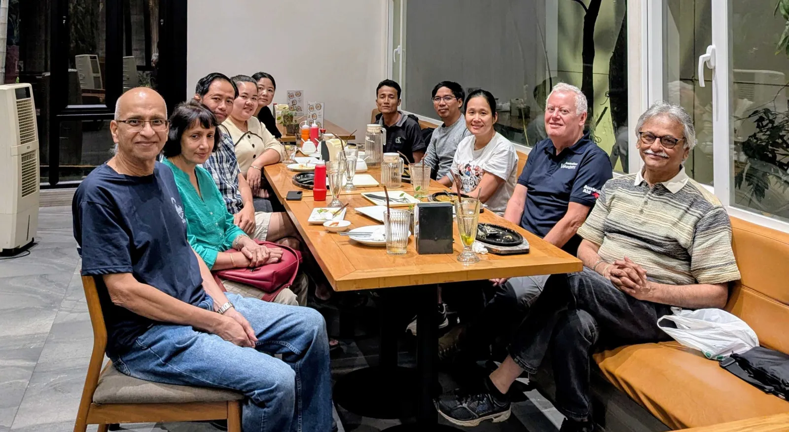 A diverse group of people sit around a table