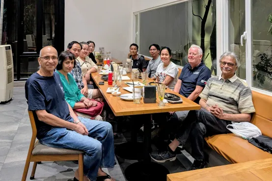A diverse group of people sit around a table