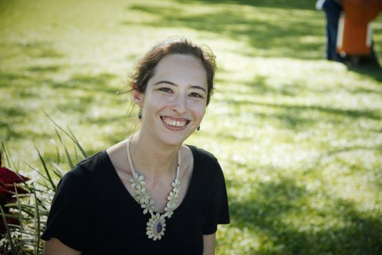 A person standing in a field of grass.